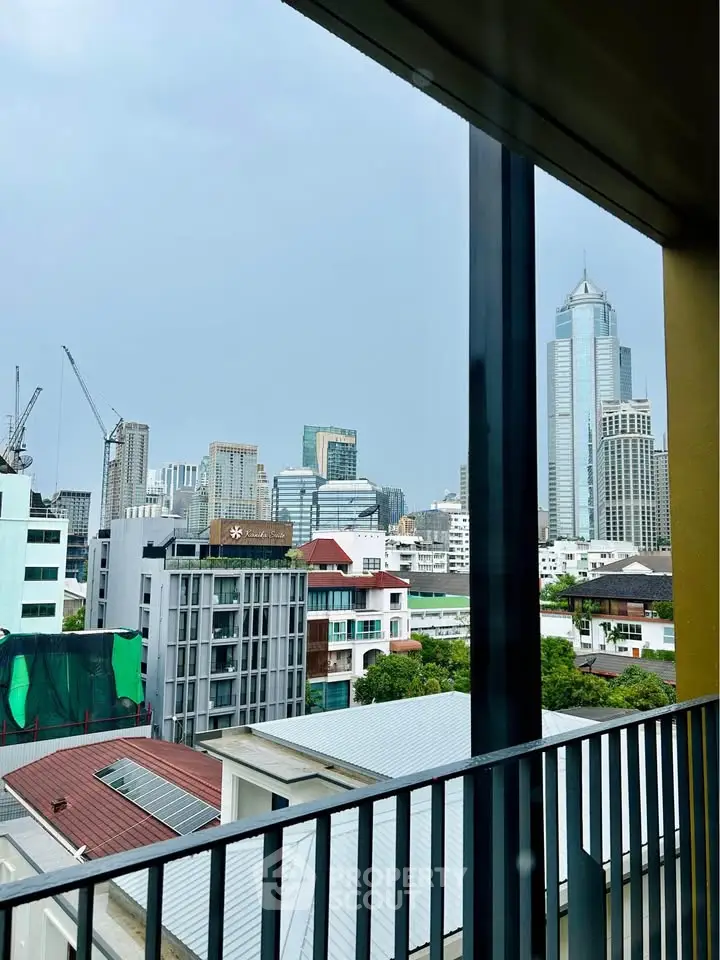 Stunning cityscape view from a modern balcony, showcasing urban skyline and architectural diversity.