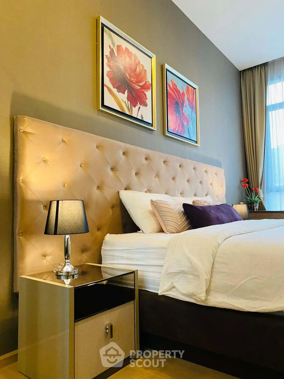 Luxurious bedroom with elegant decor and plush headboard, perfect for relaxation and comfort.