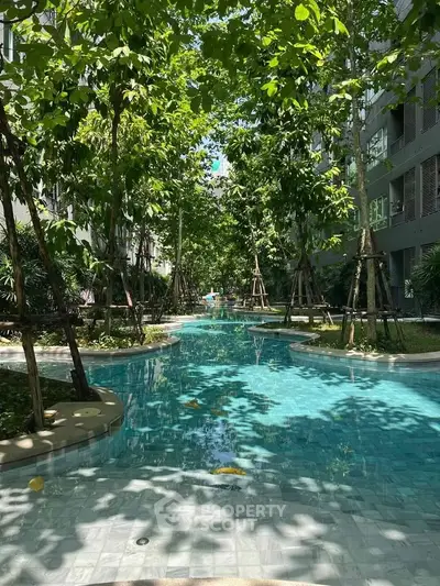 Luxurious residential pool surrounded by lush greenery and modern architecture, offering a serene oasis in the city.