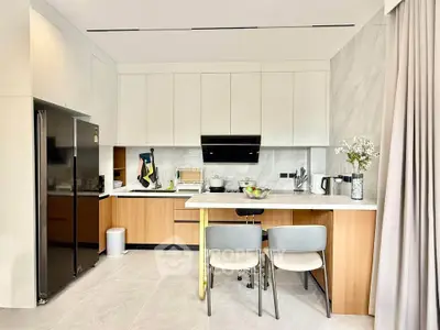 Modern kitchen with sleek cabinetry and integrated appliances in a stylish apartment.