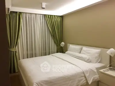Cozy bedroom with elegant green curtains and modern white bedding
