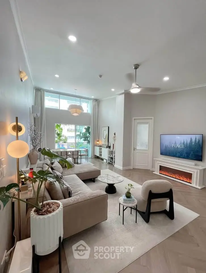 Spacious modern living room with elegant decor and large windows offering natural light.