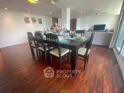 Spacious dining area with elegant wooden flooring and modern decor