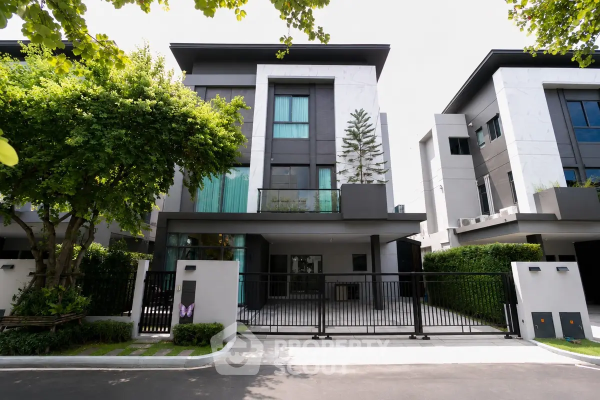 Modern luxury townhouse with sleek design and lush greenery in a serene neighborhood.