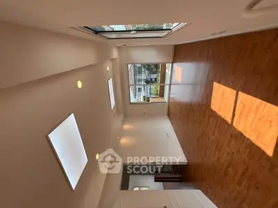 Spacious modern living room with wooden flooring and large windows