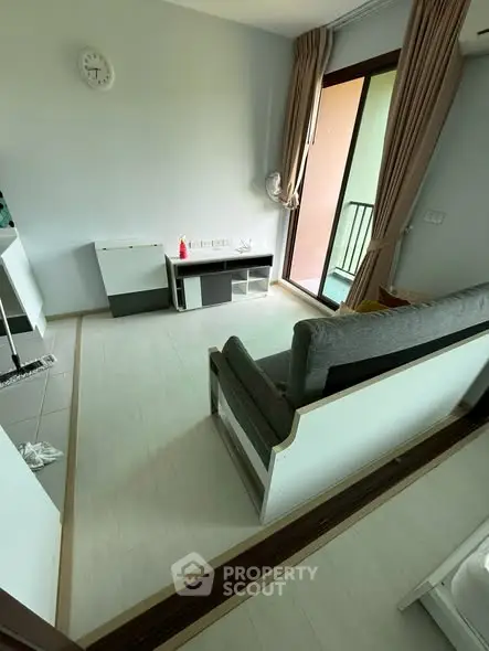 Cozy living room with balcony access and modern furnishings