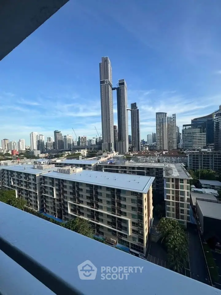 Stunning cityscape view from a high-rise balcony showcasing modern skyscrapers and urban skyline.