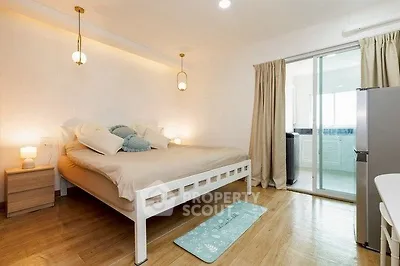 Spacious bedroom with modern decor and natural light