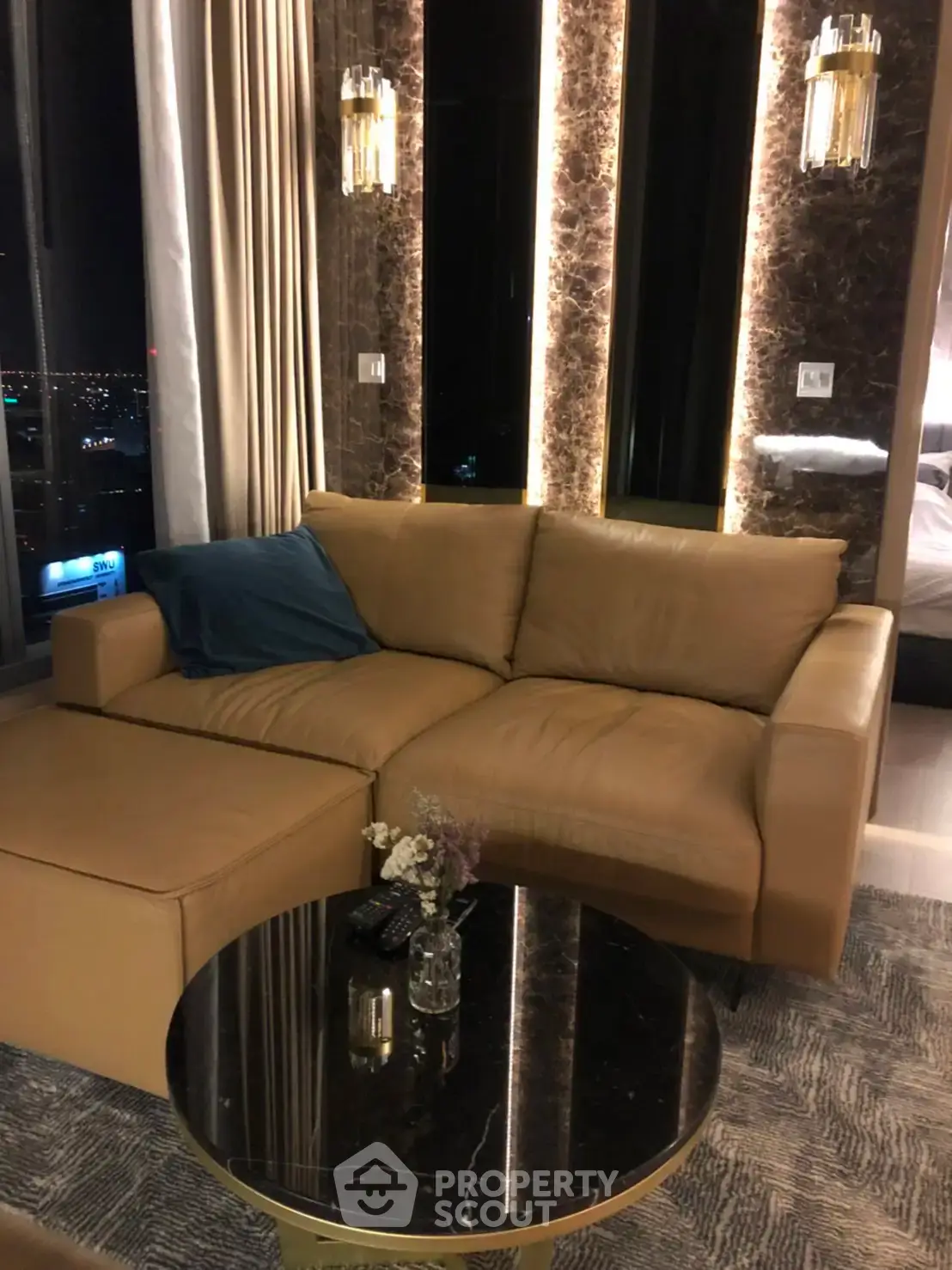 Luxurious living room with elegant sofa and city view, perfect for modern urban living.
