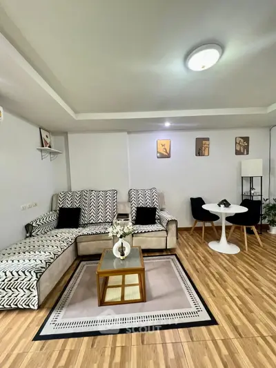 Stylish living room with modern decor and cozy seating area, perfect for relaxation and entertaining.