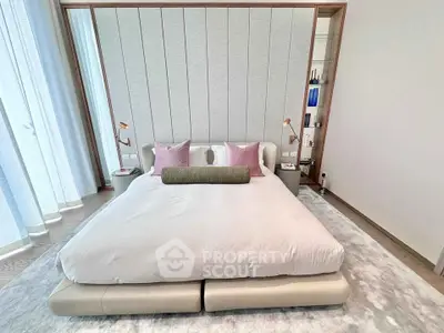 Luxurious modern bedroom with elegant decor and plush bedding, featuring stylish lighting and floor-to-ceiling windows.
