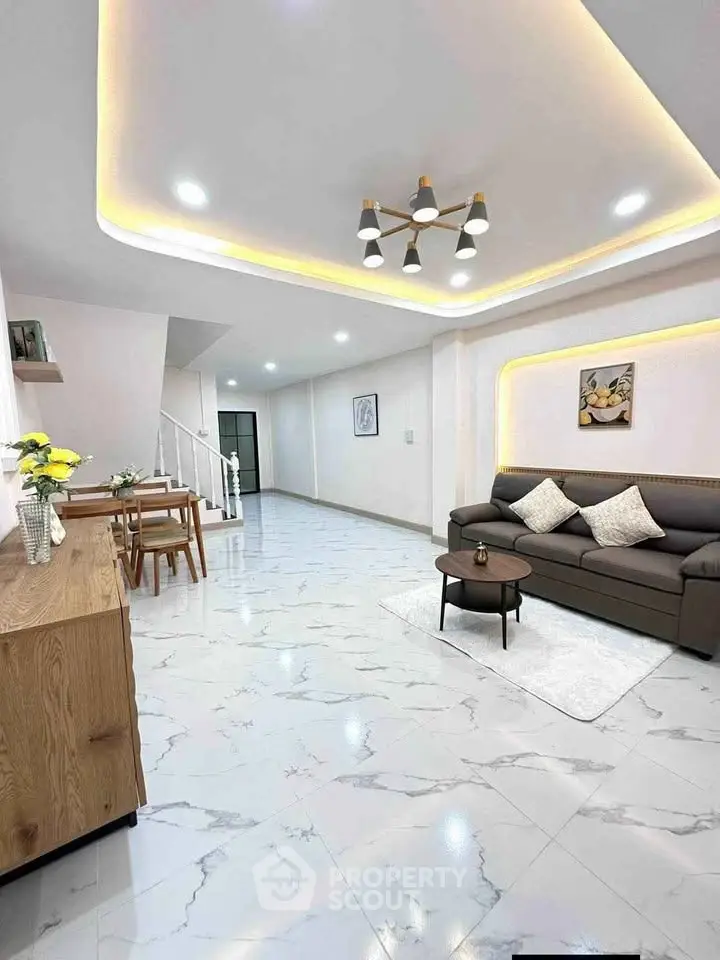 Spacious modern living room with elegant lighting and marble flooring