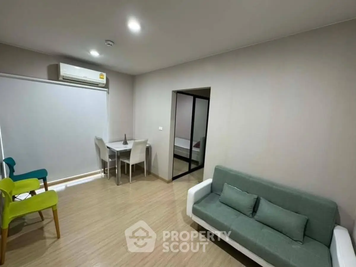 Modern living room with minimalist furniture and air conditioning in a cozy apartment.