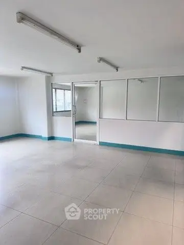 Spacious office space with large windows and modern lighting, ideal for business setup.