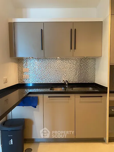 Modern kitchen with sleek cabinets and mosaic backsplash