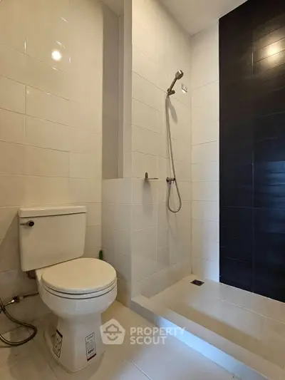 Modern bathroom with sleek shower and toilet in minimalist design