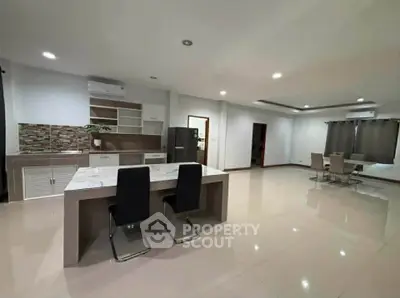 Spacious modern kitchen and dining area with sleek design and open layout