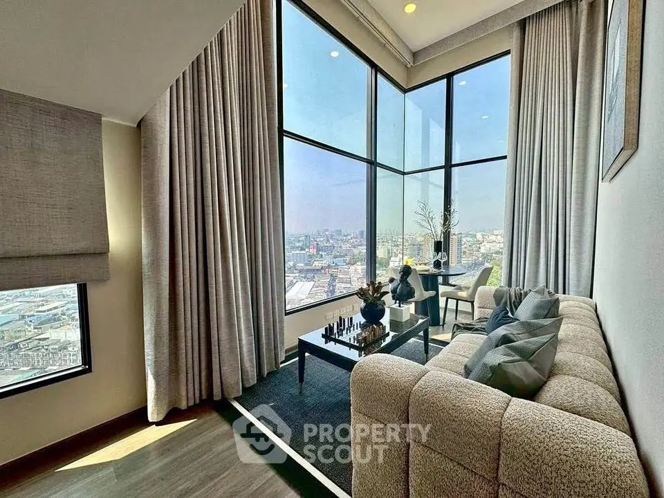 Luxurious corner living room with floor-to-ceiling windows offering stunning city views.