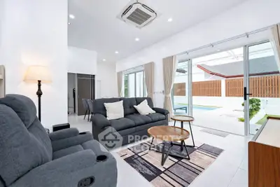 Spacious modern living room with pool view and stylish furniture