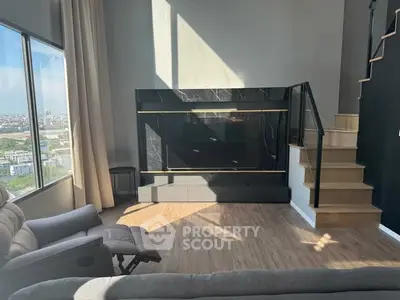 Modern living room with large windows and stylish staircase, offering a panoramic city view.