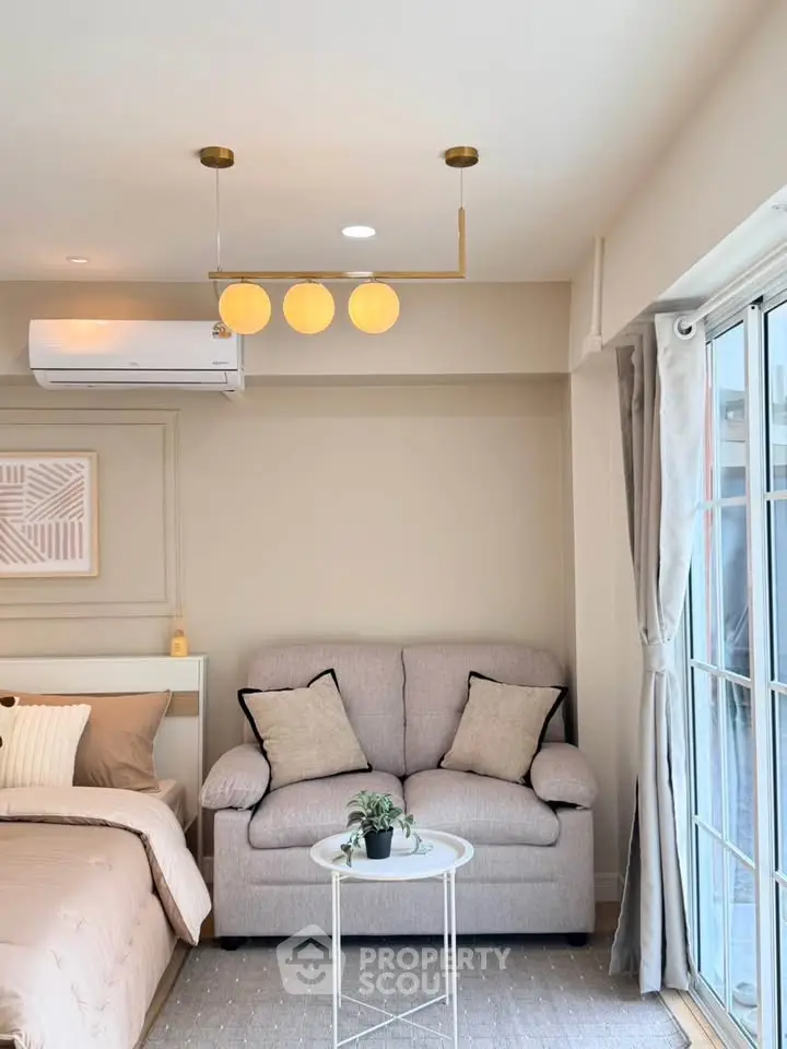 Modern studio apartment with cozy living area and stylish decor