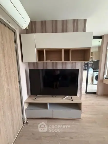 Modern living room with sleek TV unit and stylish wooden flooring