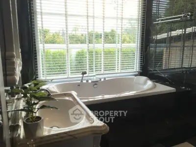 Luxurious bathroom with large bathtub and garden view