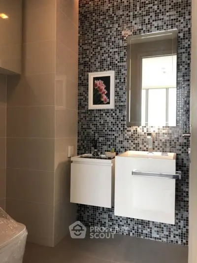 Modern bathroom with mosaic tiles and sleek vanity