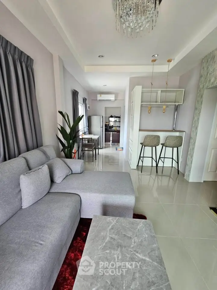 Modern living room with stylish decor and open kitchen layout in a contemporary apartment.