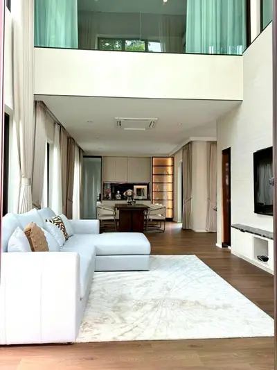 Luxurious modern living room with high ceiling and elegant decor