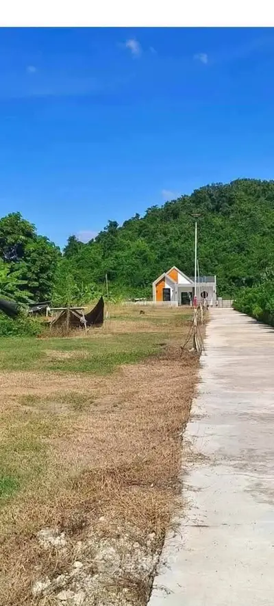 Charming countryside property with scenic views and a quaint house in lush green surroundings.