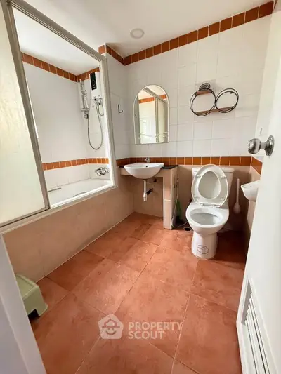 Spacious bathroom with bathtub and modern fixtures in a stylish real estate property.