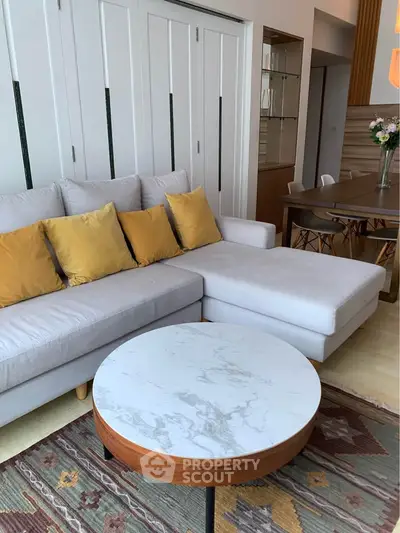Stylish living room with modern sofa and marble coffee table in a cozy apartment.
