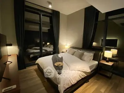 Luxurious modern bedroom with large windows and elegant decor, perfect for relaxation and comfort.