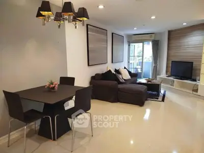 Modern living room with stylish decor and balcony view in a contemporary apartment.