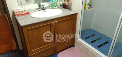 Cozy bathroom with wooden vanity and modern shower area