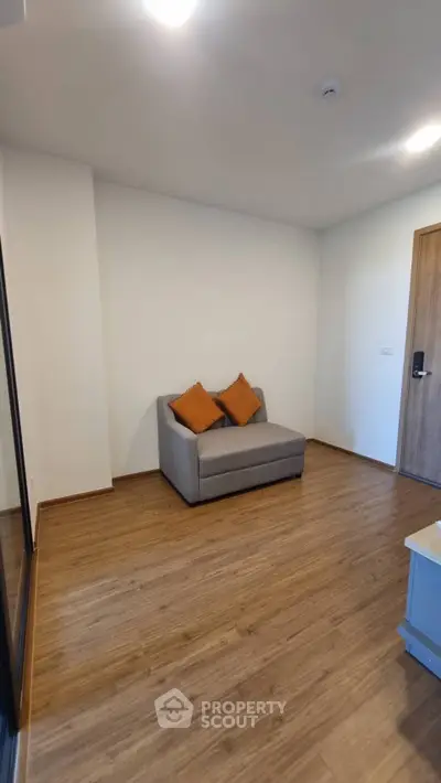 Minimalist living room with wooden flooring and cozy sofa