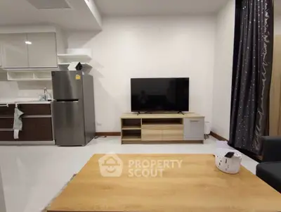 Modern living room with sleek kitchen and stylish furniture