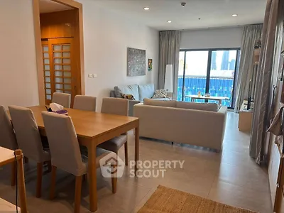 Spacious living room with modern furniture and city view, perfect for urban living.
