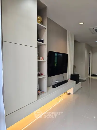 Modern living room with sleek TV setup and ambient lighting