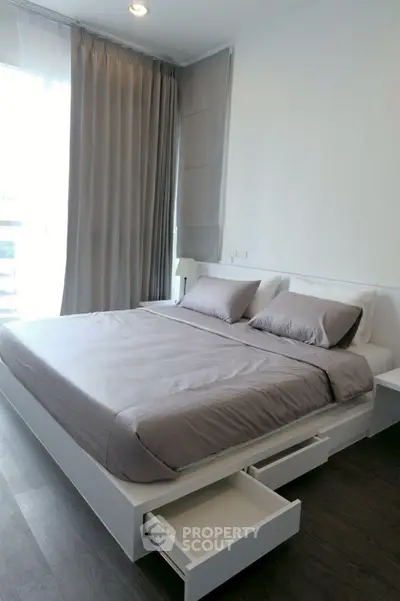 Modern bedroom with sleek design and built-in storage drawers under bed