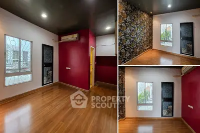 Spacious room with vibrant accent wall and wooden flooring, ideal for modern living.