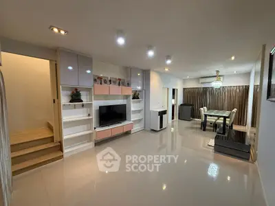 Spacious modern living room with sleek furniture and elegant dining area