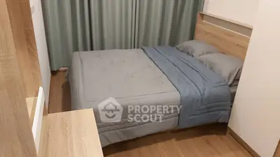 Cozy bedroom with modern wooden furniture and soft gray bedding, perfect for relaxation.