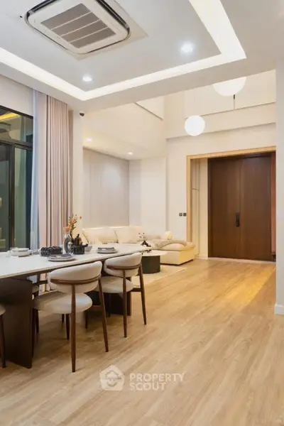 Modern living room with elegant dining area and stylish lighting