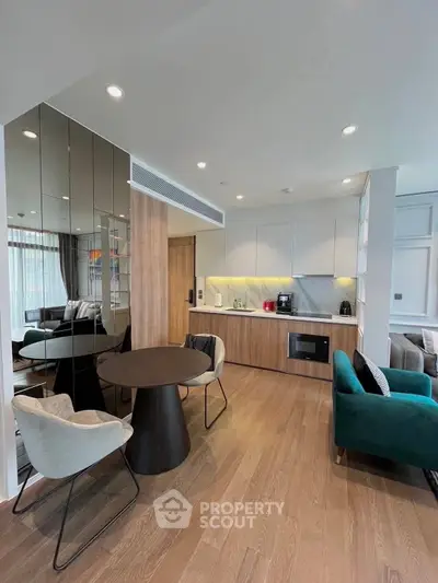 Modern open-plan living room with stylish furniture and sleek kitchen design