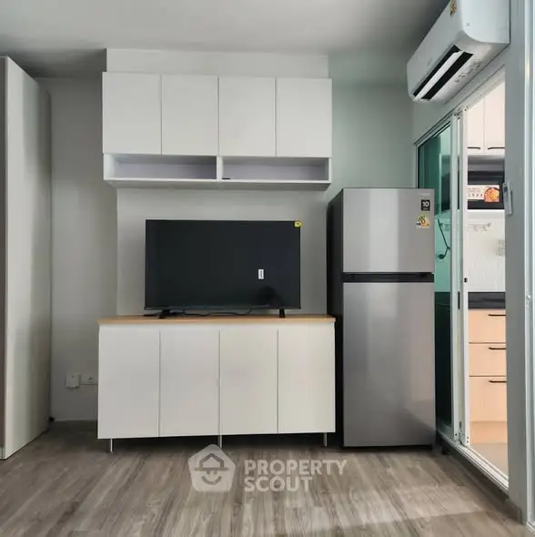 Modern living room with sleek cabinetry and stainless steel appliances