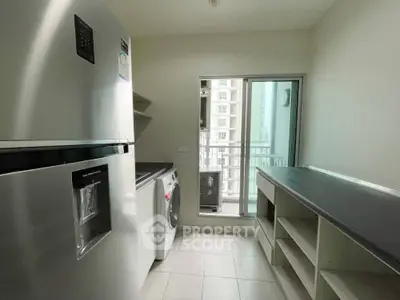 Modern kitchen with sleek appliances and ample storage space in a high-rise apartment.