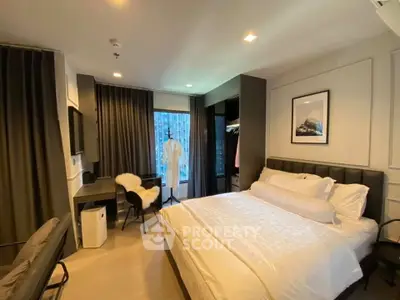 Luxurious bedroom with modern decor and large window offering city views.