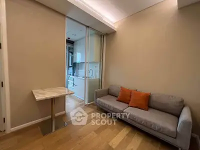 Cozy living room with modern sofa and compact kitchen in open layout